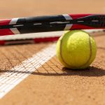 primer-plano-raqueta-de-tenis-sobre-pelota